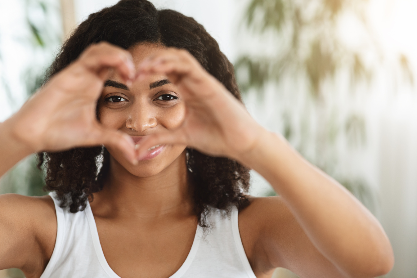 I Love Myself. Happy Woman Showing Heart Gesture And Looking Through It